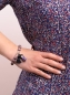 Preview: Boho Look Elastikarmband mit Holzkugeln in vintage flieder, mit lila Keramik-Puppe und Quaste